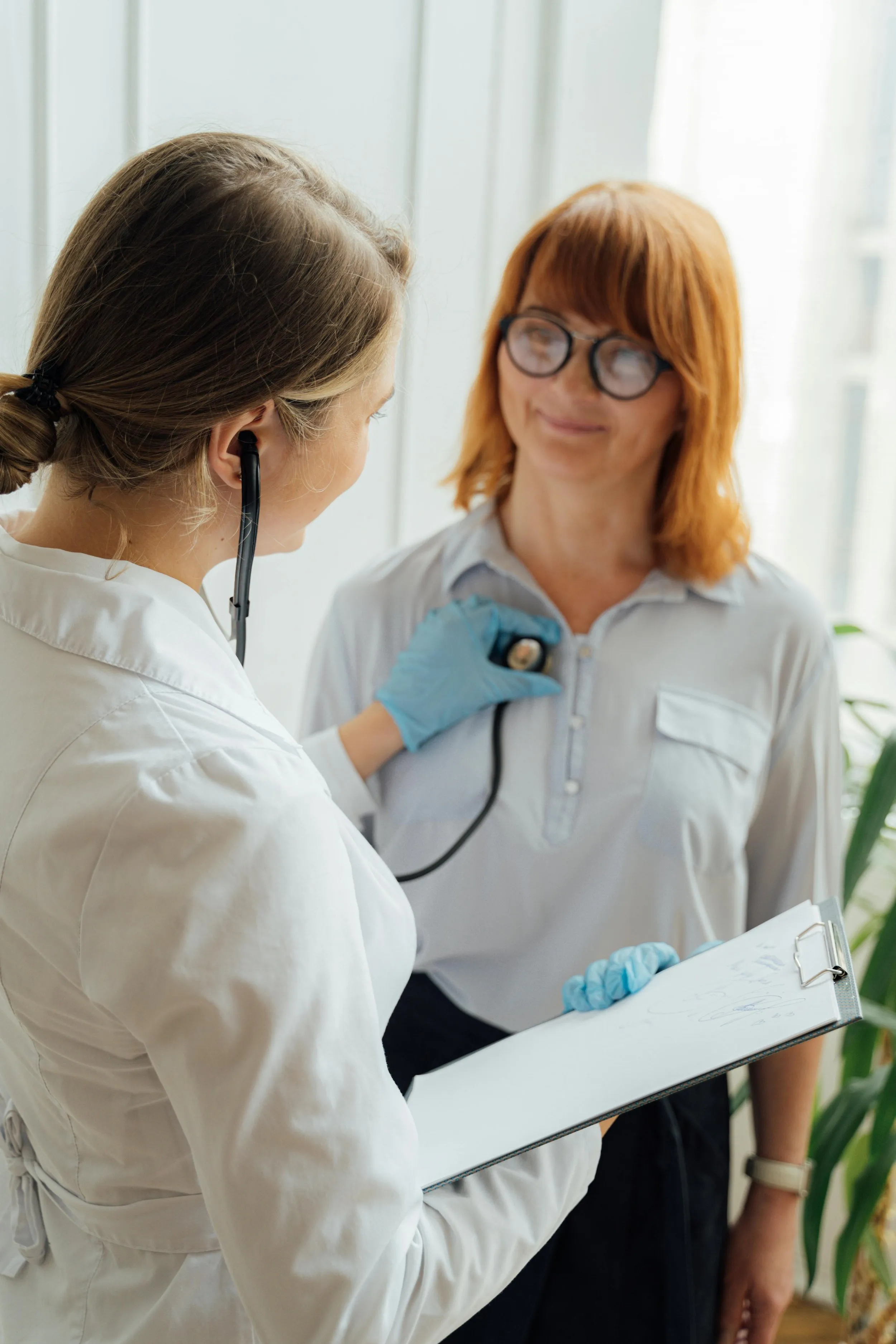 Healthcare professional using a stethoscope on a patient